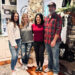 photo of Mother Cluckers owner Sabrina & family in front of Christmas tree & fireplace