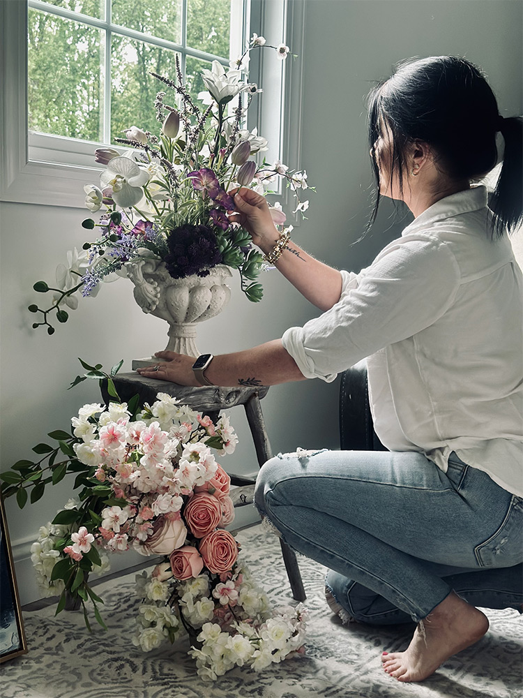 photo of Sabrina kneeling on floor, arranging flowers
